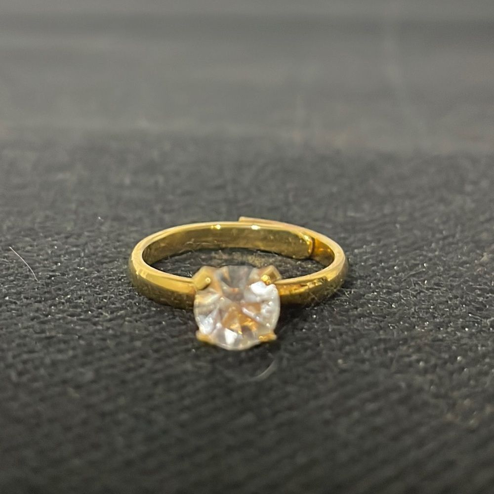 Adjustable band ring with a white gem